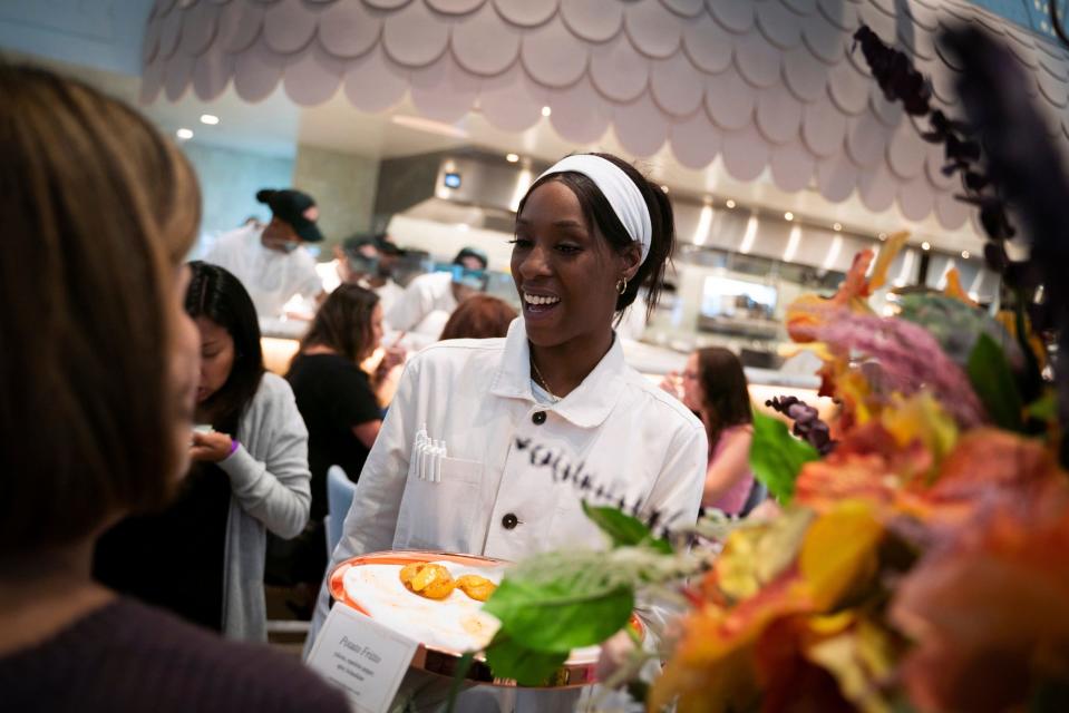 Kym Springer, 31, of Detroit, serves Potato Fritto made with yukons, espelette pepper and spicy hollandaise, during the third annual EAT Detroit event that benefits SAY Detroit charities at Mad Nice, a modern Italian restaurant, in Midtown Detroit on Tuesday, June 27, 2023.