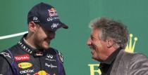 Red Bull Formula One driver Sebastian Vettel of Germany (L) talks to racing legend Mario Andretti after winning the U.S. F1 Grand Prix final at the Circuit of the Americas in Austin, Texas November 17, 2013.