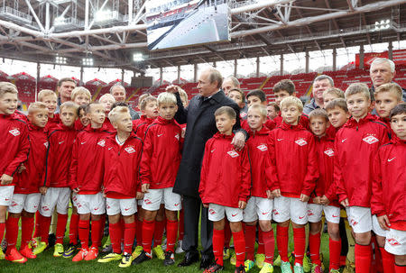 FILE PHOTO: Russian President Vladimir Putin talks to young soccer players during a visit to Spartak's stadium Otkrytie Arena in Moscow, Russia August 27, 2014. REUTERS/Sergei Karpukhin/File Photo