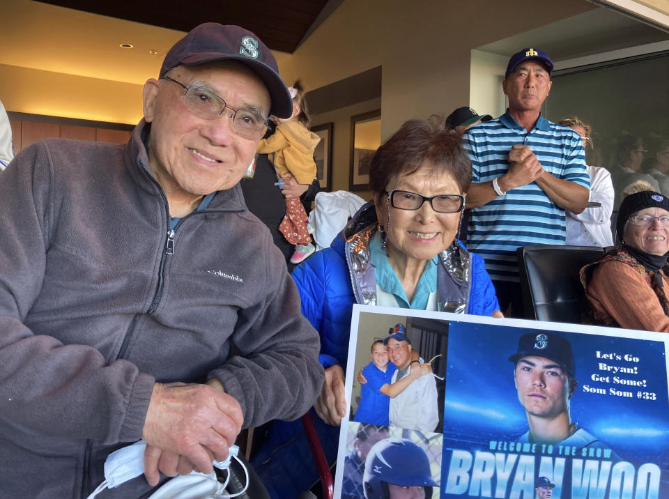 The grandparents of Seattle Mariners rookie pitcher Bryan Woo pose for a photo in San Francisco during a baseball game between the Mariners and the San Francisco Giants, Monday, July 3, 2023. John, 93, left, and Nancy, 85, front right, are from El Cerrito, Calif., and are getting to see their grandson pitch back home in the Bay Area where he grew up in Alameda. (AP Photo/Janie McCauley)