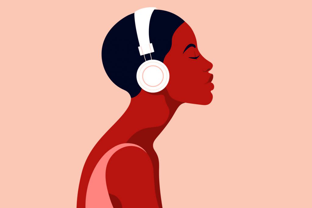 A woman listens to something on her headphones.