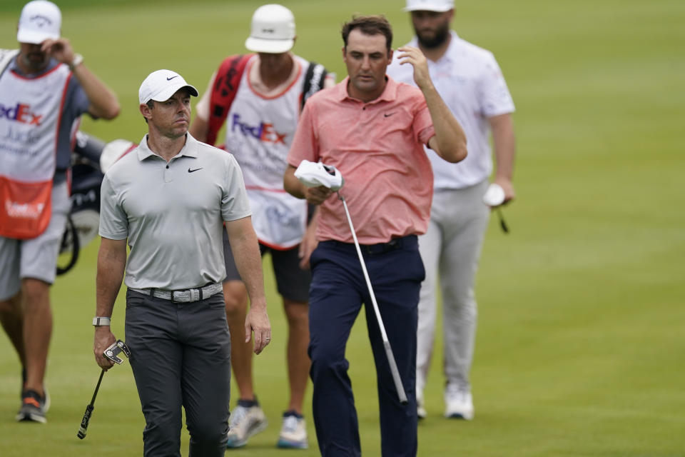 From left, Rory McIlroy, Scottie Scheffler, and Jon Rahm walk together on the ninth fairway during the first round of the St. Jude Championship golf tournament Thursday, Aug. 10, 2023, in Memphis, Tenn. (AP Photo/George Walker IV)