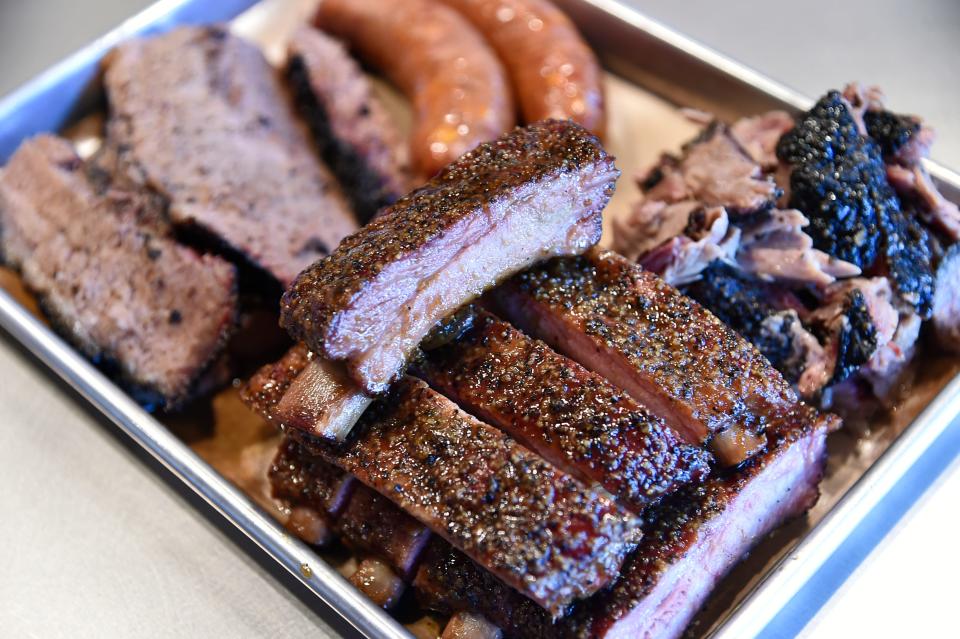A meat platter of Brick's Smoked Meats in downtown Sarasota consisting of. St. Louis Ribs, USDA Prime Brisket, Jalapeno and Cheddar House Sausage, and Pulled Pork. The restaurant is located at 1528 State St.