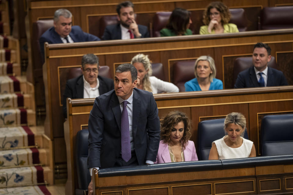 Spain's Socialist Prime Minister Pedro Sanchez, foreground and left, votes at the Spanish parliament's lower house in Madrid on Thursday, May 30, 2024. Spain's Parliament has given final approval to a controversial amnesty law for hundreds of Catalan separatists involved in the illegal and unsuccessful 2017 secession bid. The legislation was backed in the lower house by Spain's left-wing coalition government, two Catalan separatist parties, and other smaller parties. It passed despite the conservative Popular Party and far-right Vox voting against it. (AP Photo/Bernat Armangue)