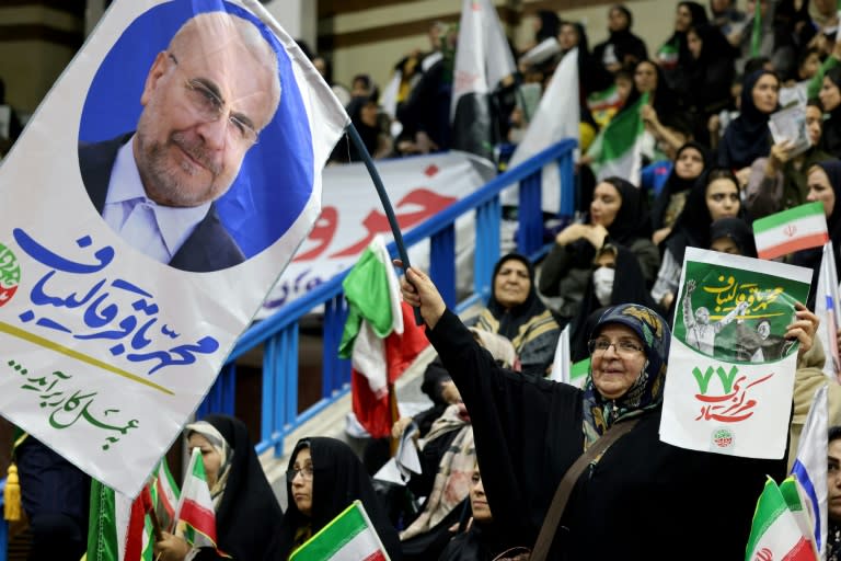 An Iranian woman waves a banner in support of conservative parliament speaker Mohammad Bagher Ghalibaf at a rally in Tehran (ATTA KENARE)