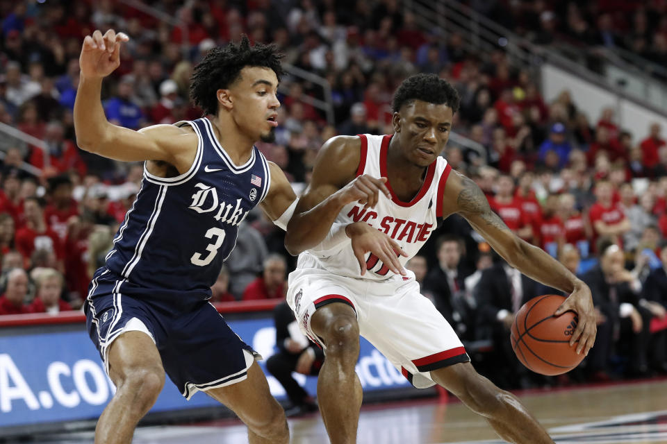 Duke guard Tre Jones (3) guards North Carolina State guard Markell Johnson (11) during the first half of an NCAA college basketball game in Raleigh, N.C., Wednesday, Feb. 19, 2020. (AP Photo/Gerry Broome)