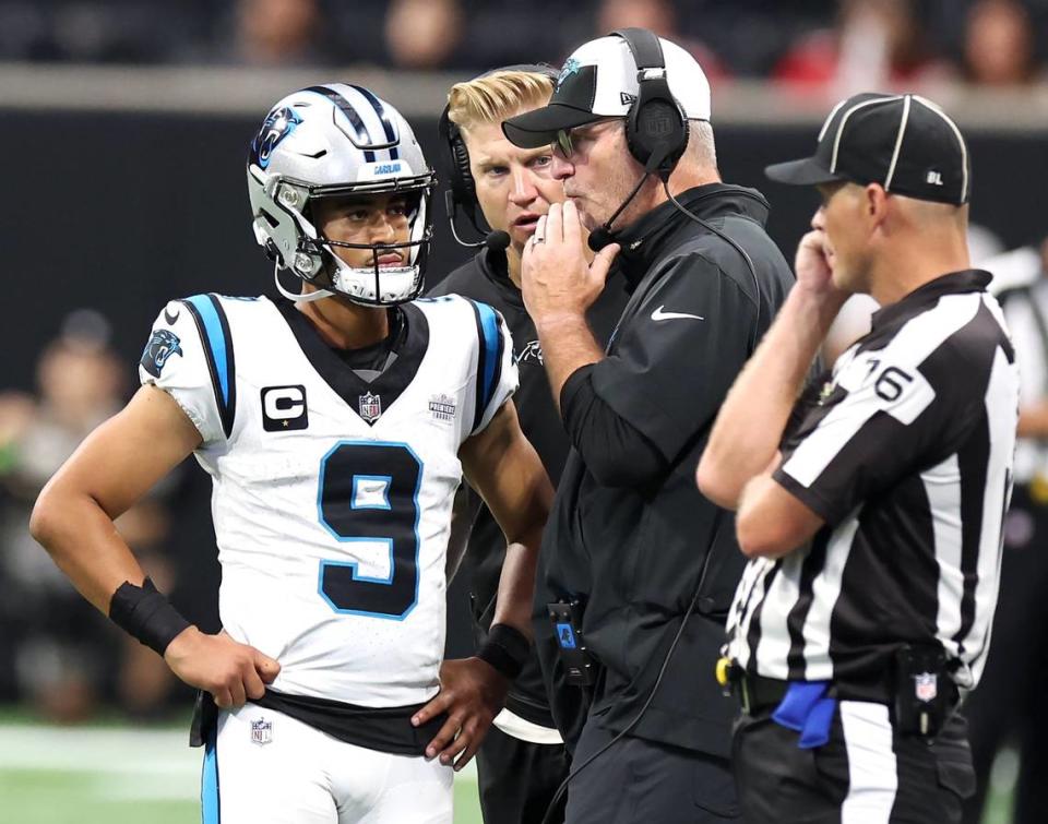 Carolina Panthers quarterback Bryce Young, left, quarterbacks coach Josh McCown, center, gather around head coach Frank Reich, right, during fourth-quarter action against the Atlanta Falcons at Mercedes-Benz Stadium in Atlanta, GA on Sunday, September 10, 2023. The Falcons defeated the Panthers 24-10.