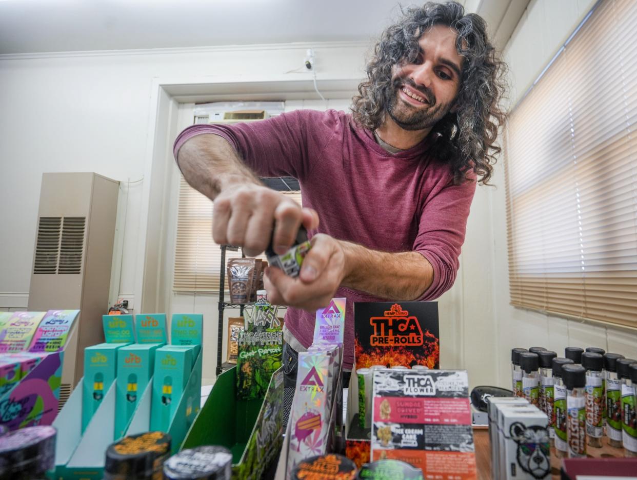 Darren Brook shows his products at Barge Cannabis in West Bend. He offers delta-8, THCA and more. They are psychoactive like conventional marijuana but are legal under the federal Farm Bill of 2018.