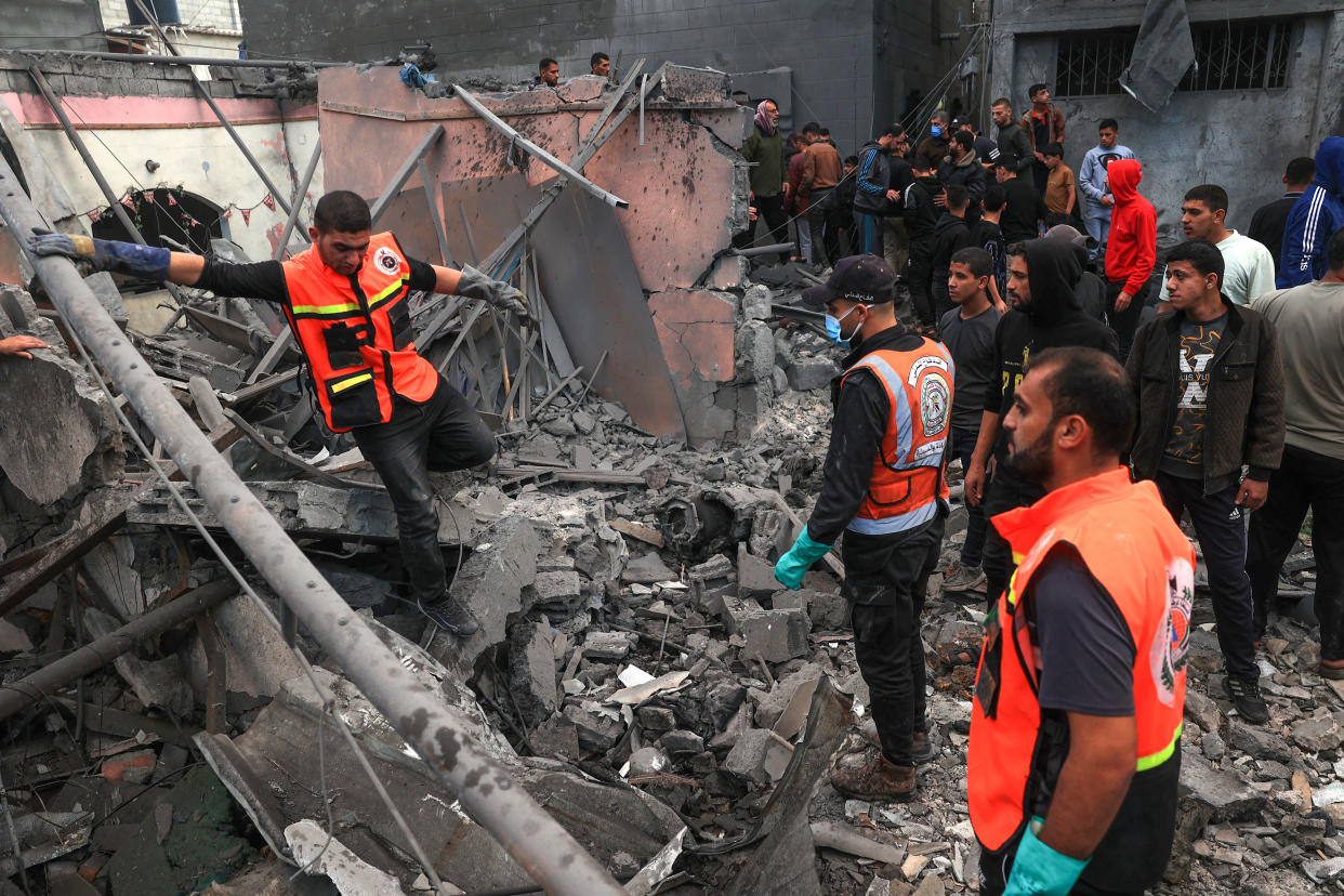 Palestinian medics search for survivors in the rubble of a building following Israeli bombardment in Rafah in the southern Gaza Strip on December 1, 2023, as fighting resumed shortly after the expiration of a seven-day truce between Israel and Hamas militants. A temporary truce between Israel and Hamas expired on December 1, with the Israeli army saying combat operations had resumed, accusing Hamas of violating the operational pause. (Photo by SAID KHATIB / AFP) (Photo by SAID KHATIB/AFP via Getty Images)