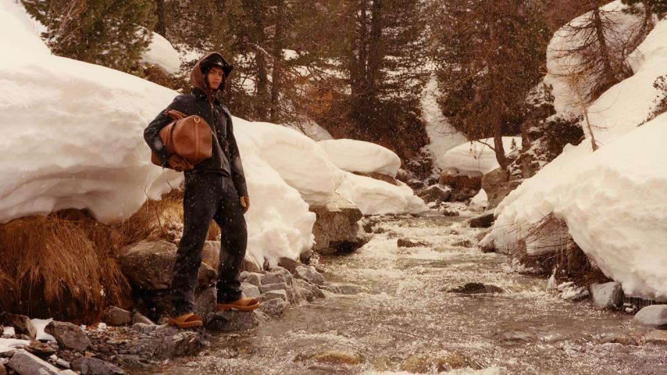 a man standing on a snowy trail