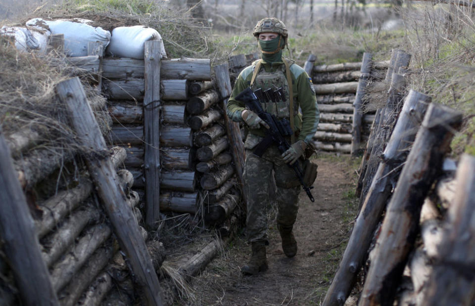 A Ukrainian serviceman patrols along a trench in Schastya, Lugansk region, near the frontline with Russia backed separatists.