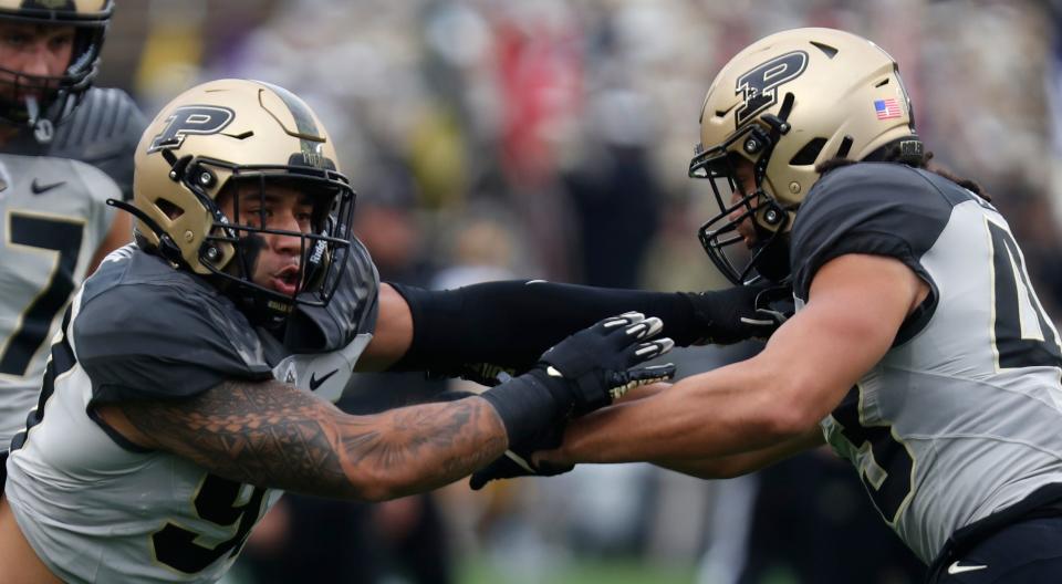 Purdue Boilermakers linebacker Semisi Fakasiieiki (97) and Purdue Boilermakers linebacker Kieren Douglas (43) warm up ahead of the NCAA football game against the Iowa Hawkeyes, Saturday, Nov. 5, 2022, at Ross-Ade Stadium in West Lafayette, Ind. Iowa won 24-3.