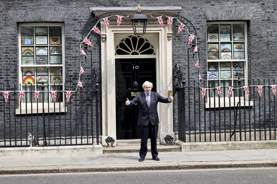 Britain's Prime Minister Boris Johnson poses for the media outside Downing Street, to mark the 75th anniversary of VE Day, in London, Friday, May 8, 2020. (Jon Bond/Pool Photo via AP)