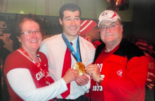 Marleau poses with his parents, Jeanette and Denis, after winning a gold medal at the 2010 Vancouver Olympic Games. 