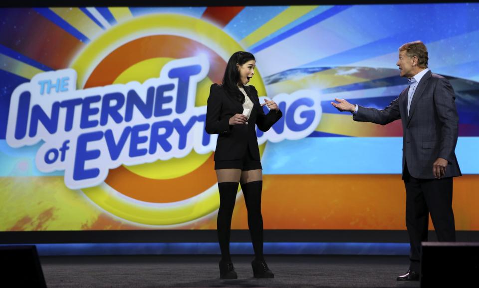 Cisco CEO John Chambers talks with comedian Sarah Silverman during Chambers' keynote address at the annual Consumer Electronics Show (CES) in Las Vegas