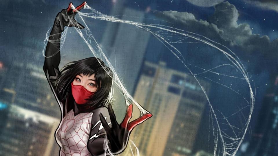 Siny Moon aka Silk in her masked costume with webs against a city skyline