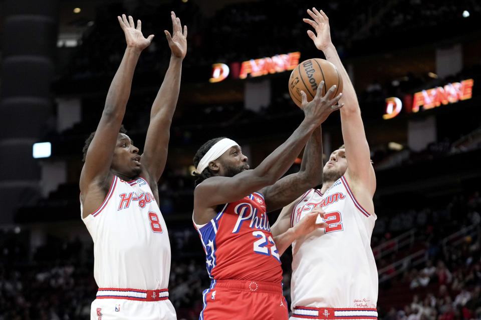 Philadelphia 76ers guard Patrick Beverley (22) shoots as Houston Rockets forward Jae'Sean Tate (8) and center Jock Landale defend during the first half of an NBA basketball game Friday, Dec. 29, 2023, in Houston. (AP Photo/Eric Christian Smith)