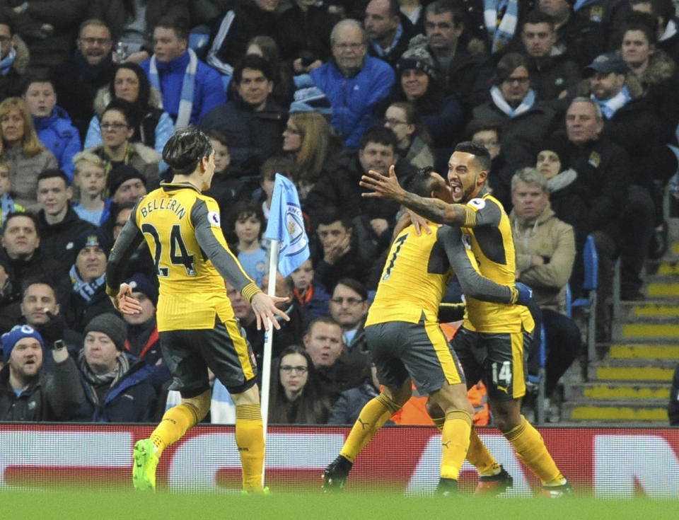 <p>Arsenal’s Theo Walcott, right, celebrates after scoring during the English Premier League soccer match between Manchester City and Arsenal at the Etihad Stadium in Manchester, England, Sunday, Dec. 18, 2016. (AP Photo/Rui Vieira) </p>