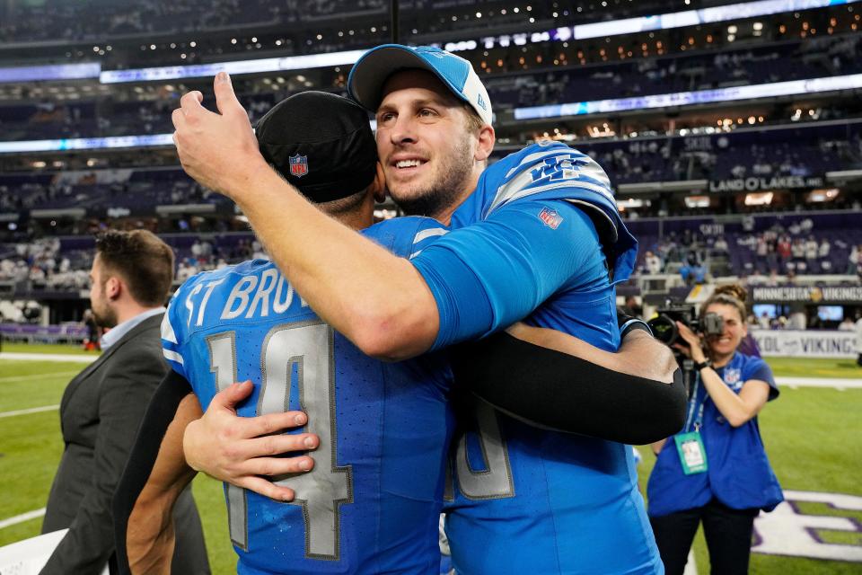 Jared Goff #16 and Amon-Ra St. Brown #14 of the Detroit Lions celebrate the 30-24 win against the Minnesota Vikings at U.S. Bank Stadium on December 24, 2023 in Minneapolis, Minnesota.