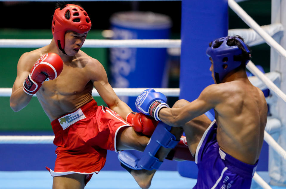 Southeast Asian Games - Kickboxing - Men's 60kg Final - Cuneta Astrodome, Pasay, Philippines - December 10, 2019      Laos' Taipanyavong Soukan and Indonesia's Lumbantungkup Bonatua in action  REUTERS/Eloisa Lopez