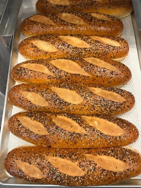 Freshly baked bread with everything seasoning waits to be used for sandwiches at DiBella's Subs' new Worthington location.