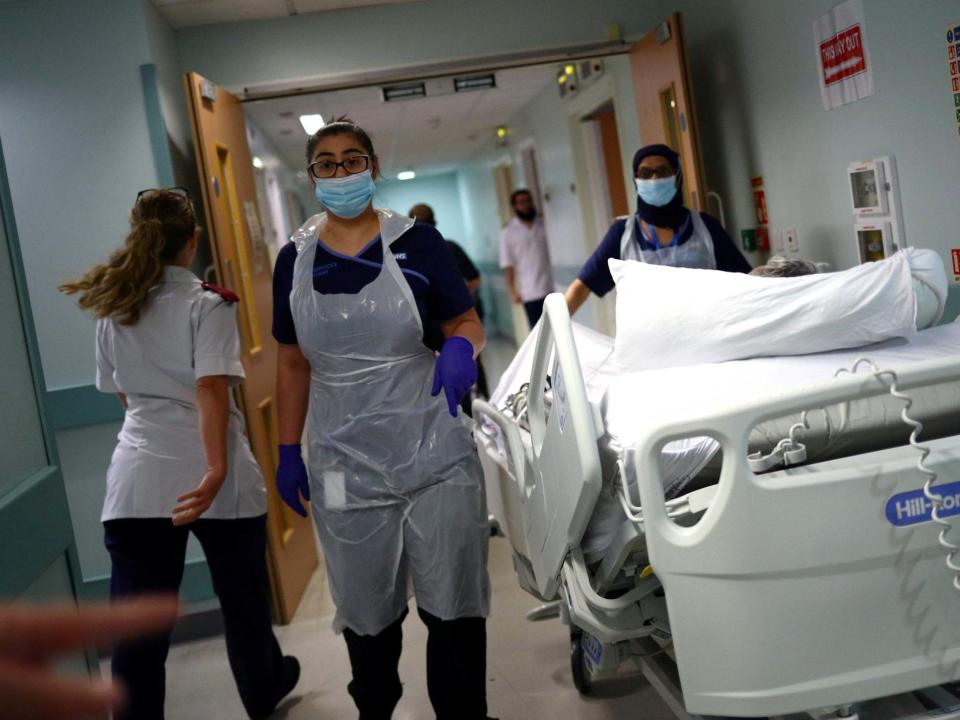 Medical staff transfer a patient along a corridor at the Royal Blackburn Teaching Hospital in Blackburn, north-west England on May 14, 2020: AFP/Getty