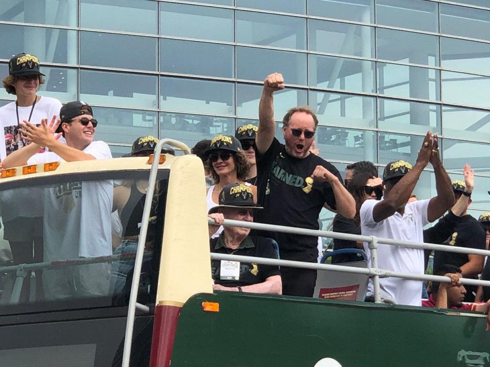 Milwaukee Bucks coach Mike Budenholzer celebrates near the start of the parade following the Bucks' 2021 NBA championship.