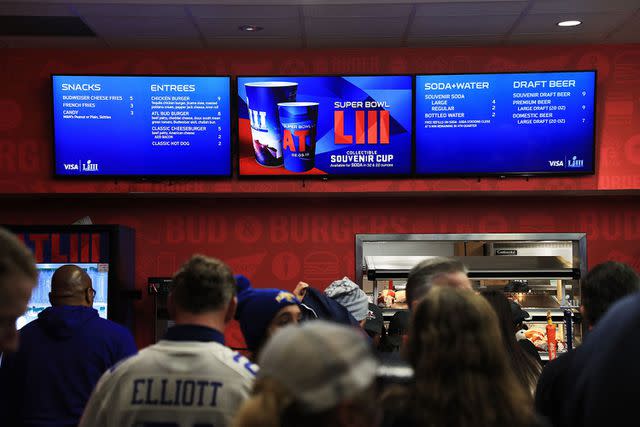 <p>Mike Ehrmann/getty</p> Food and beverage options are seen on signs at Super Bowl LIII in Atlanta in 2019.