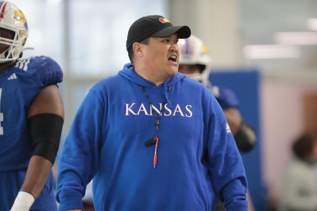 Kansas football offensive line coach Daryl Agpalsa looks on during a practice on April 2, 2024, inside the team's indoor practice facility.