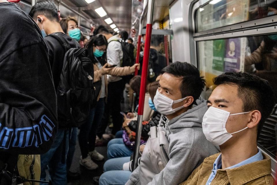 People wearing masks are seen riding the train in Hong Kong on Jan. 22. 