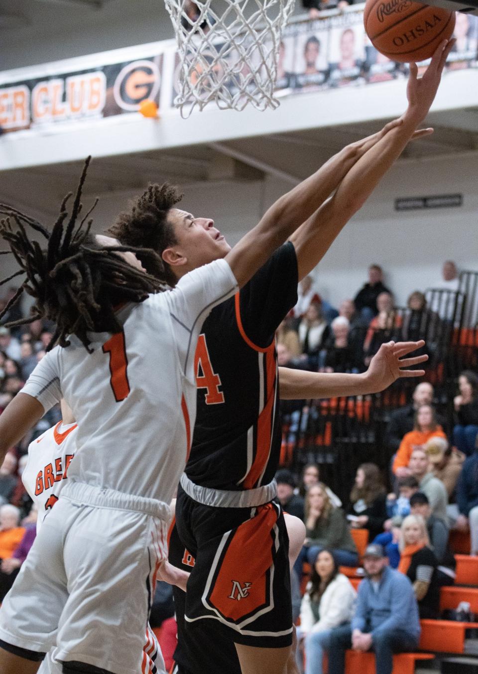 Hoover’s Elijah Barker goes up for a shot against Green's Jarrett Taylor on Friday, Jan. 21, 2022.