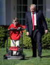 <p>President Donald Trump (R) walks with 11-year-old Frank “FX” Giaccio (L) while he mows the grass in the Rose Garden of the White House September 15, 2017 in Washington, DC. Giaccio, from Falls Church, Virginia, who runs a business called FX Mowing, wrote a letter to Trump expressing admiration for Trump’s business background and offered to mow the White House grass. (Photo: Win McNamee/Getty Images) </p>