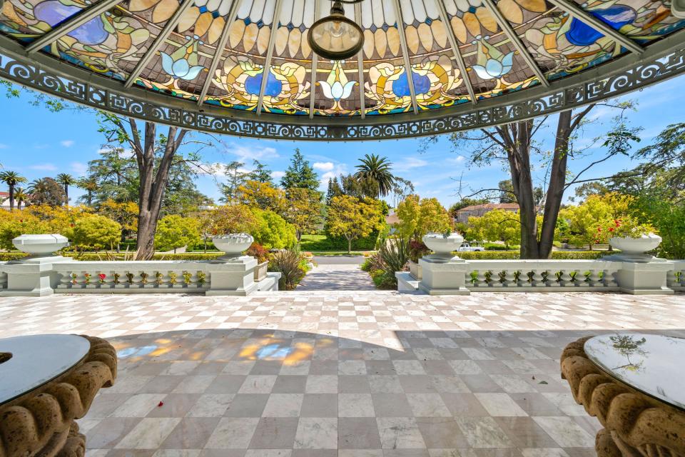 This mansion in a gated part of Fremont Place, within Hancock Park, Los Angeles, used to belong to boxing champion Muhammad Ali. It is up for auction, listed at $13.5 million.