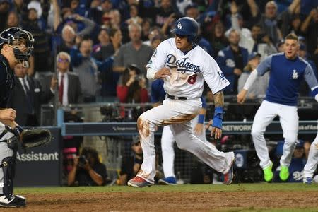 Oct 16, 2018; Los Angeles, CA, USA; Los Angeles Dodgers shortstop Manny Machado (8) runs home to score on an RBI single by center fielder Cody Bellinger (not pictured) defeat the Milwaukee Brewers in the thirteenth inning in game four of the 2018 NLCS playoff baseball series at Dodger Stadium. Mandatory Credit: Richard Mackson-USA TODAY Sports