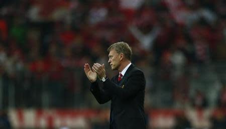 Manchester United's manager David Moyes applauds after their Champions League quarter-final second leg soccer match against Bayern Munich in Munich, April 9, 2014 file photo. REUTERS/Michael Dalder