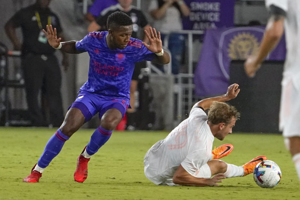 Orlando City midfielder Andres Perea, left, and FC Dallas midfielder Paxton Pomykal work to get possession of the ball during the second half of an MLS soccer match, Saturday, May 28, 2022, in Orlando, Fla. (AP Photo/John Raoux)
