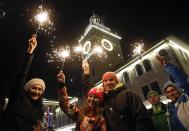 People celebrate ahead of New Year's Day in the centre of Rosa Khutor, a venue of the Sochi 2014 winter Olympics, some 40 kilometres (25 miles) east from Sochi December 31, 2013. REUTERS/Maxim Shemetov (RUSSIA - Tags: SPORT SOCIETY OLYMPICS) )