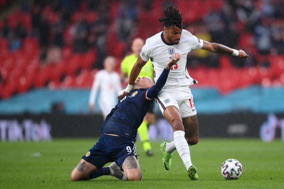 Lyndon Dykes is challenged by Tyrone Mings (Getty)