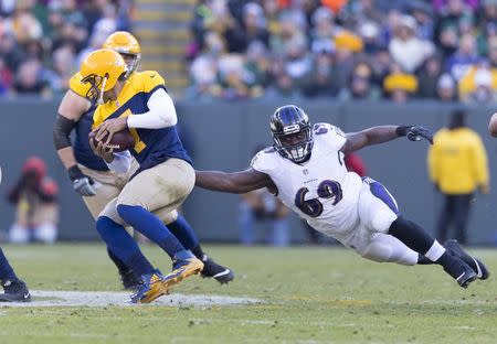 Nov 19, 2017; Green Bay, WI, USA; Baltimore Ravens defensive tackle Willie Henry (69) dives trying to tackle Green Bay Packers quarterback Brett Hundley (7) during the third quarter at Lambeau Field. Mandatory Credit: Jeff Hanisch-USA TODAY Sports