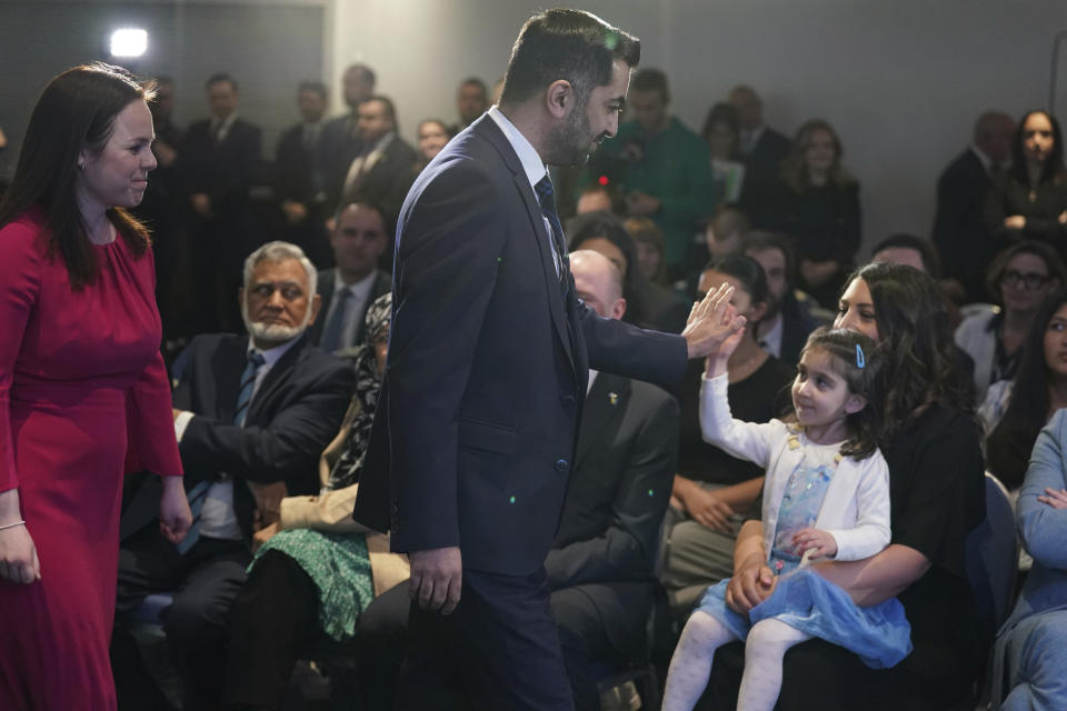 Humza Yousaf, centre, gestures with his wife Nadia El-Nakla and daughter Amal after he was announced as the new SNP leader, at Murrayfield Stadium, in Edinburgh, Scotland, Monday, March 27, 2023. Scotland’s governing Scottish National Party elected Yousaf as its new leader on Monday after a bruising five-week contest that exposed deep fractures within the pro-independence movement. The 37-year-old son of South Asian immigrants is set to become the first person of color to serve as Scotland’s first minister. (Andrew Milligan/PA via AP)