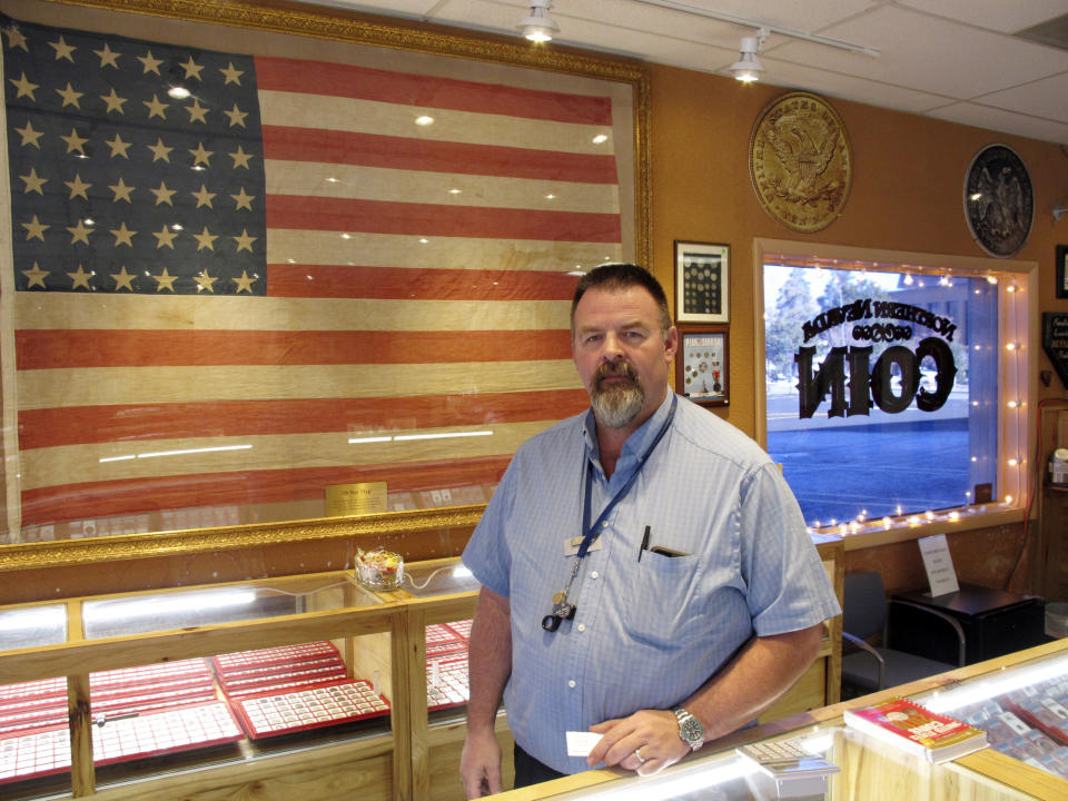 Allen Rowe, owner of Northern Nevada Coin, poses for a photo Thursday, Jan. 24, 2019, in his pawn and coin shop in Carson City, Nev., where he bought items earlier this month from a man suspected in a string of four homicides. Rowe says Wilbur Martinez-Guzman, of El Salvador, used his passport as identification to sell jewelry that investigators say were stolen from two victims. (AP Photo/Scott Sonner)