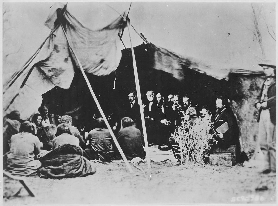 An image captured in 1868 shows U.S. Army Gen. William T. Sherman and Sioux leaders at Fort Laramie, Wyoming, signing a peace treaty that recognized the Black Hills as part of the Great Sioux Reservation. Its terms disintegrated after U.S. officials sought to annex the land, rumored to have gold. The event formed the basis for a 1980 Supreme Court ruling that found the U.S. had taken the tribal lands illegally.