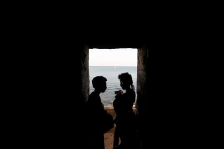 Tourists stand at the 'Door of No Return' as they visit the 'Maison Des Esclaves' slaves house, a gathering point where slaves were shipped west in the 1700s and 1800s, at Goree Island off the coast of Dakar