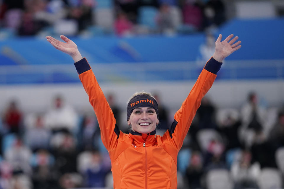 Irene Schouten of the Netherlands reacts at a flower ceremony after winning the gold medal and breaking the Olympic record in the women's speedskating 3,000-meter race at the 2022 Winter Olympics, Saturday, Feb. 5, 2022, in Beijing. (AP Photo/Sue Ogrocki)