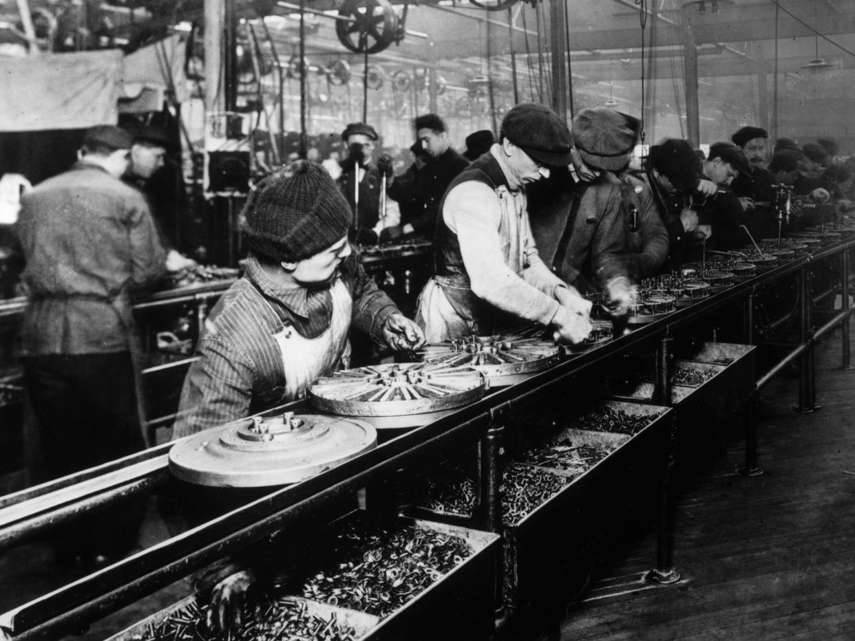 1914: Flywheel production at the Ford motor plant in Highland Park, Michigan.