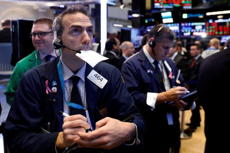 Traders work on the floor of the New York Stock Exchange shortly after the opening bell in New York, U.S., November 15, 2017. REUTERS/Lucas Jackson