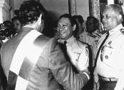 <p>Gen. Manuel Noriega, center, congratulates Panama’s new provisional president, Francisco Rodriguez, with his back to the camera, on Sept. 1, 1989, in Panama City. At right is Lt. Col. Luis Cordoba, a member of the defense forces general staff. (AP Photo) </p>