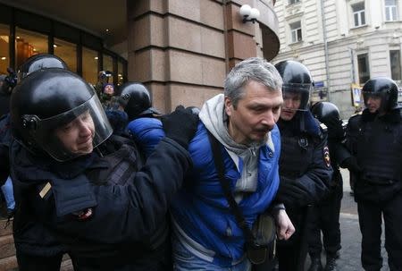 Policemen detain a man during an unsanctioned anti-government protest in central Moscow, Russia, April 2, 2017. REUTERS/Maxim Shemetov