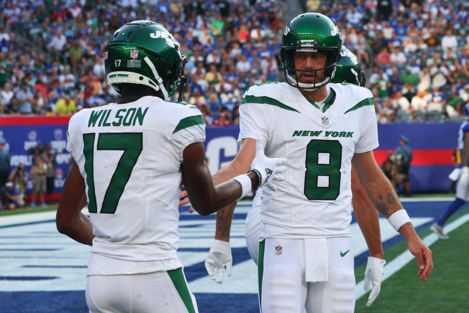 New York Jets quarterback Aaron Rodgers (8) celebrates a touchdown pass against the New York Giants at MetLife Stadium.