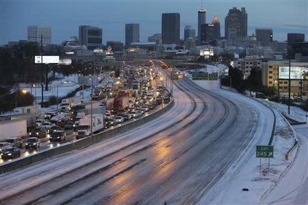 The Atlanta southbound connector is clogged with traffic as the connector northbound is an empty sheet of ice due to a snow storm in Atlanta, Georgia, January 29, 2014. REUTERS/Ben Gray/Atlanta Journal/Constitution/Handout via Reuters